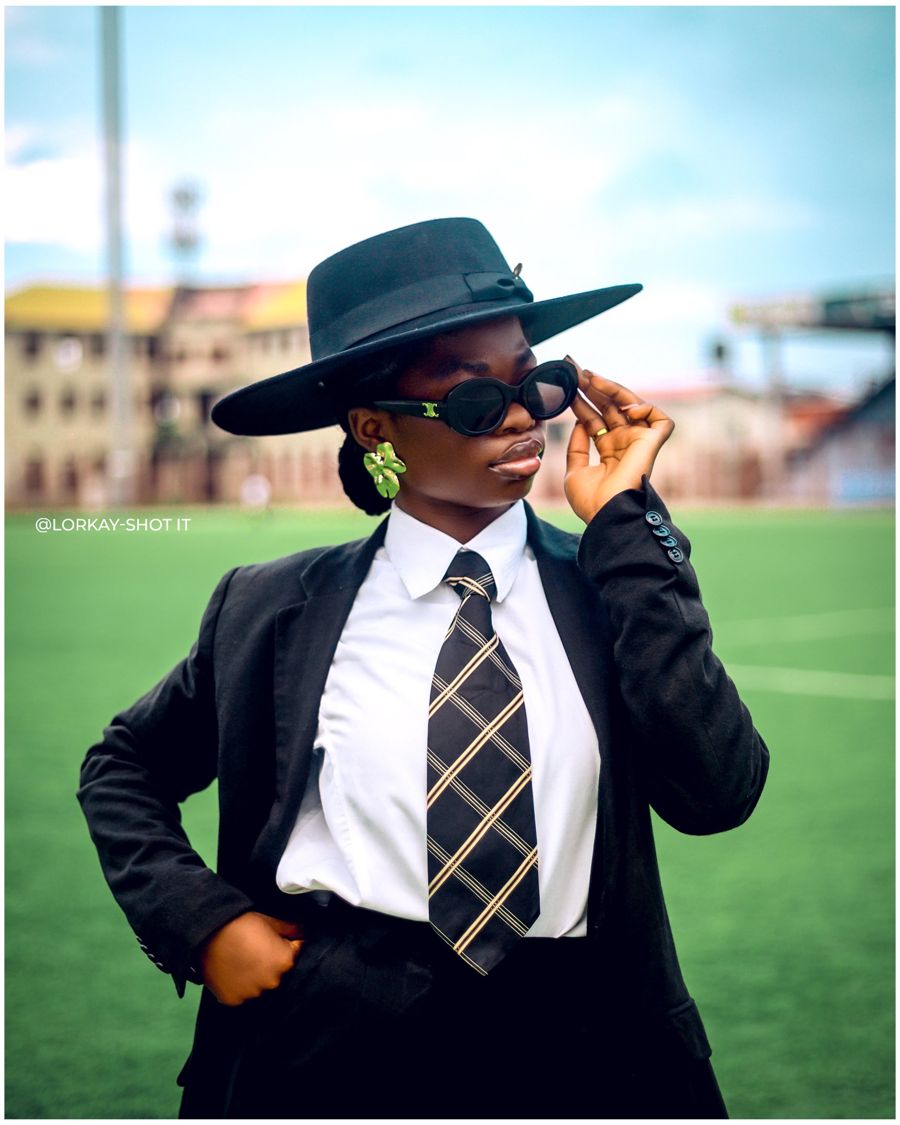 Olubunmi Elizabeth in a black hat and sunglasses